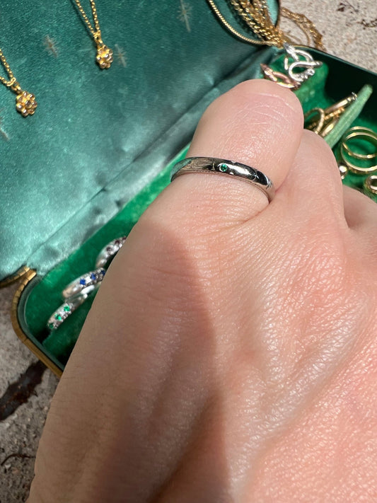 I saved this engraved 18k white gold band from the melt pile and flush set a Colombian emerald into it to add a little sparkle.