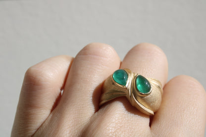 Toi et moi rings: the most romantic of rings. Symbolizing two parts of a whole, or symbolizing the interconnected nature of our internal tensions. I think there's something scared about this type of interlocking geometry and there's an infinite world of glamour inside of this specific form.&nbsp; Natural Colombian emeralds nestled in nearly raw recycled 10k gold are pictured.