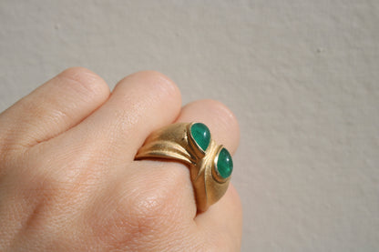 Toi et moi rings: the most romantic of rings. Symbolizing two parts of a whole, or symbolizing the interconnected nature of our internal tensions. I think there's something scared about this type of interlocking geometry and there's an infinite world of glamour inside of this specific form.&nbsp; Natural Colombian emeralds nestled in nearly raw recycled 10k gold are pictured.